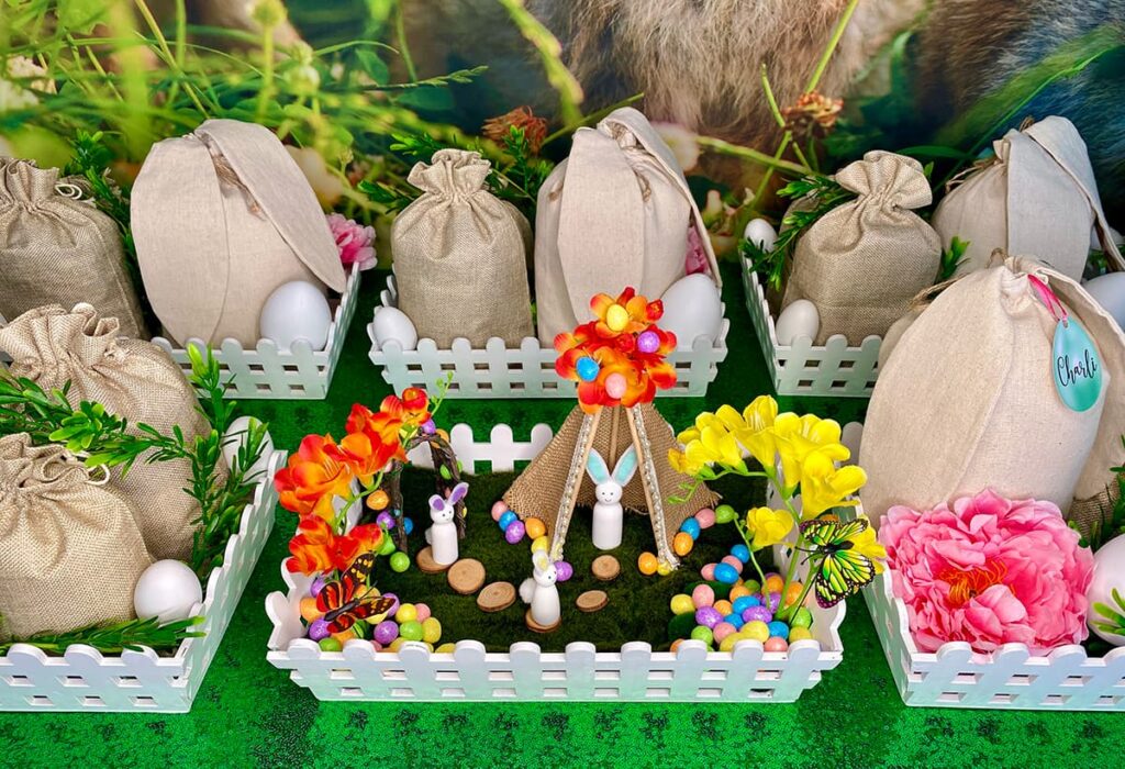 Detailed view of Easter fairy garden party table showing one completed and decorated activity crate surrounded by other crates in their original presentation.