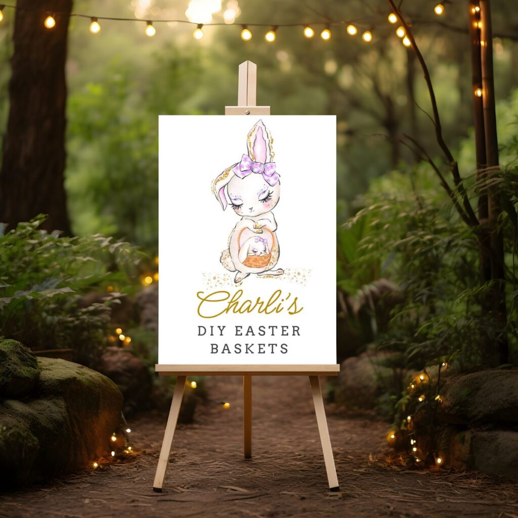 DIY Easter Baskets sign on an easel with an enchanted forest background, showing a bunny holding a basket with a baby bunny. Printable by Inspired Party Design.