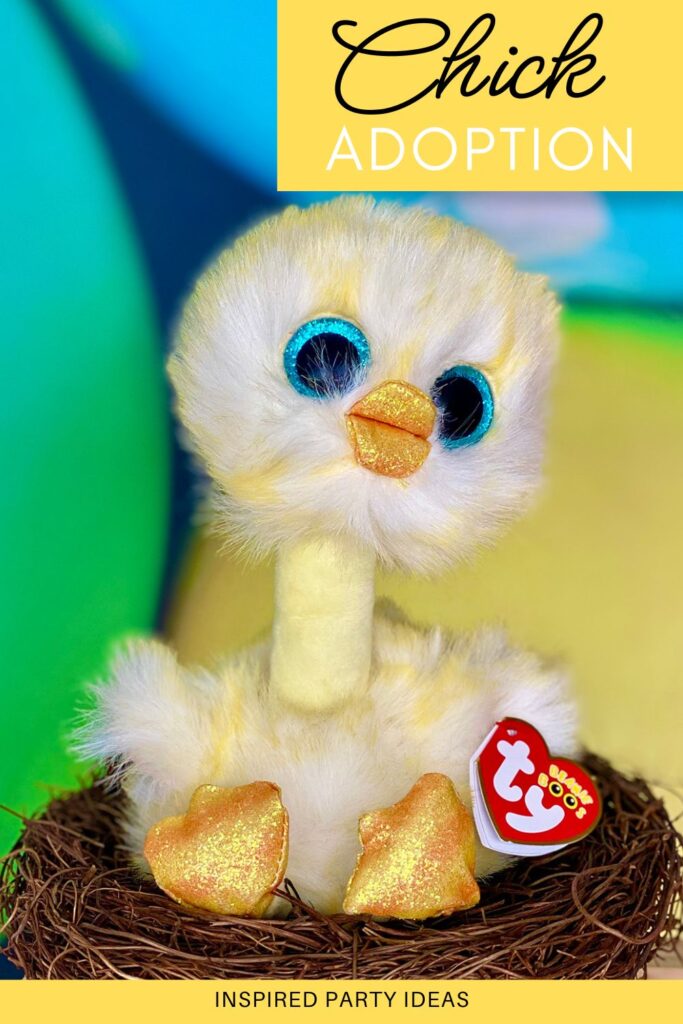 Plush Beanie Boo chick sitting in a faux nest with colorful Easter eggs in the background.