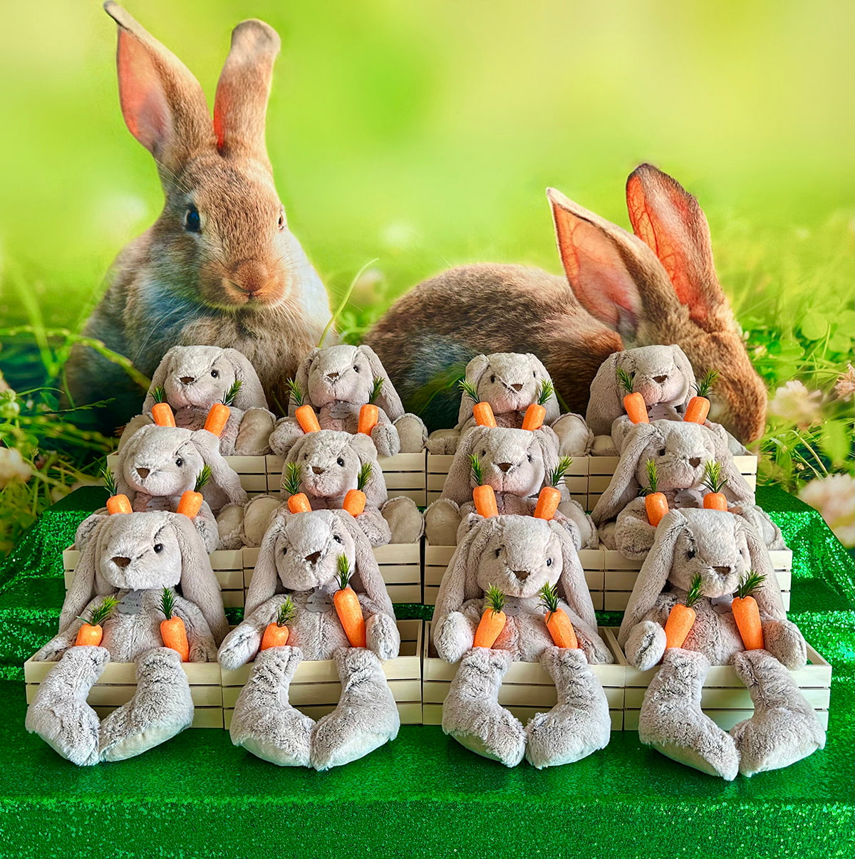 Front-facing view of an Easter Bunny Adoption setup featuring rows of plush bunnies with carrots against a grassy springtime bunny backdrop.