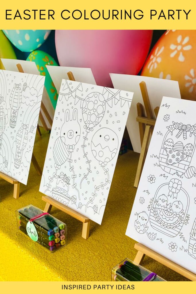 Side view of Easter colouring party table with egg backdrop, yellow sequin tablecloth, easels with uncoloured posters, and markers with egg name tags.