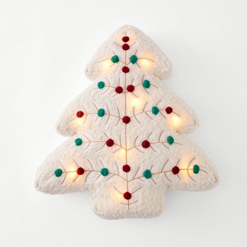 LED light-up Christmas tree pillow with a soft fabric design, used as a fun prop for kids’ Christmas party games.
