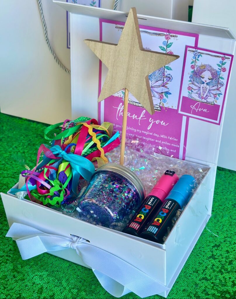 DIY fairy wand kit kids party favour with wooden star wand, Posca paint pens, ribbon, trim and glitter jar in white gift box with thank you card and personalised name tag.