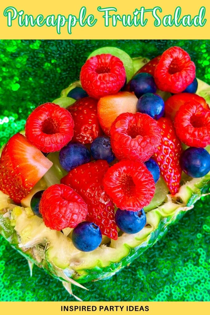 Fresh berry fruit salad served in a hollowed-out pineapple for a kids pineapple party.