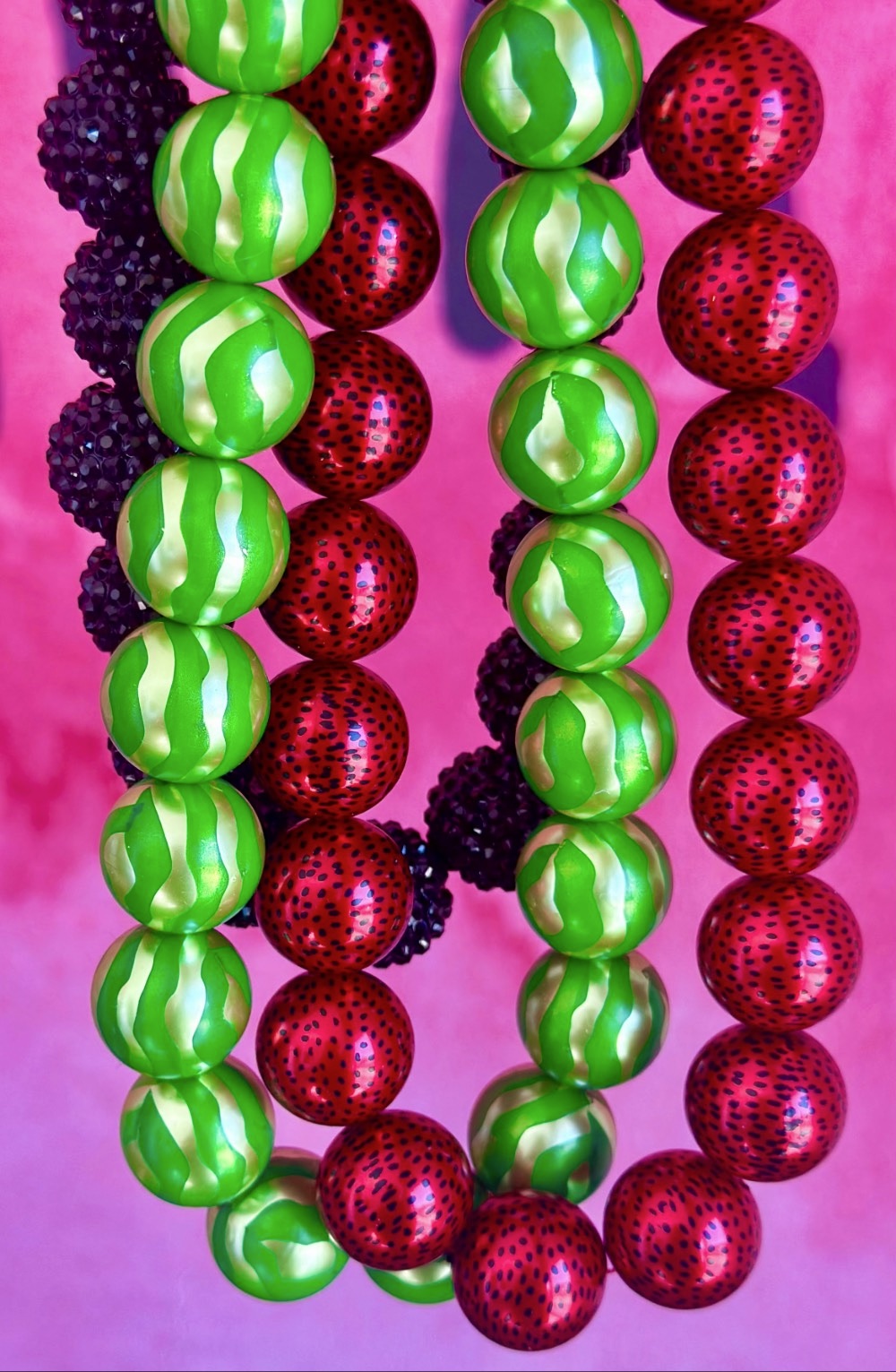 Close-up of handmade watermelon bead necklaces with colourful fruit-inspired bubblegum beads.